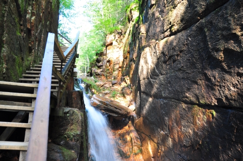 Free Picture: Photo of a wooden walkway ascending on the side of a rock face near a waterfall at Flume Gorge, Franconia State Park.