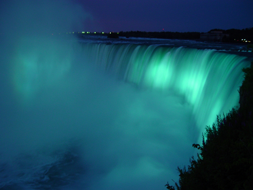 Photo of Horseshoe Falls at Niagara Falls Glowing Aqua at Night