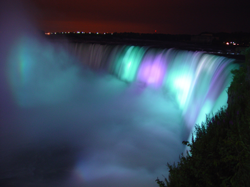 Free Picture: Photo of Niagara Falls lit up at night in purple and aqua in the summer taken from the Ontario, Canada side.