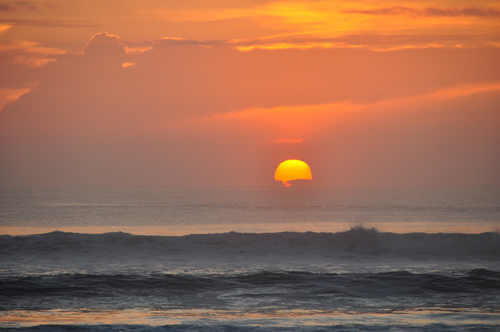 Free Picture: Photo of a sunrise peeking through clouds making it just slightly hazy.